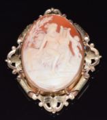 A 9ct gold brooch set with a cameo depicting a woman playing a harp with Cupid, 26.7g, 5.7 x 6.7cm