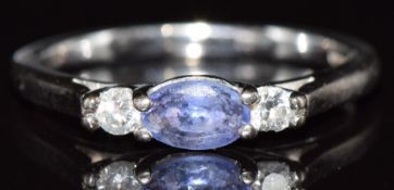An 18ct white gold ring set with an oval cut tanzanite and diamonds, 3.5g, size P