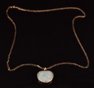 A 9ct gold pendant set with jadeite and a 9ct gold curb link chain 3.7g, 57cm long