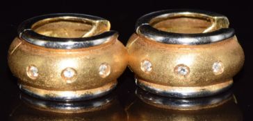 A pair of 18ct gold bi-coloured earrings set with three diamonds to each, 11.6g