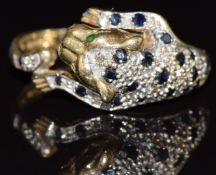 A 9ct gold ring in the form of a leopard set with sapphires, diamonds and emeralds, 4.1g, size Q