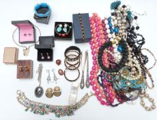 A collection of jewellery including bangles, two silver mounted items, beads, abalone necklace,