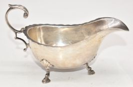 George V hallmarked silver sauce boat with shaped edge, raised on three feet, London 1928, maker