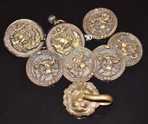 Seven Japanese Meiji period metal buttons with decoration in relief and a figural lion clasp,