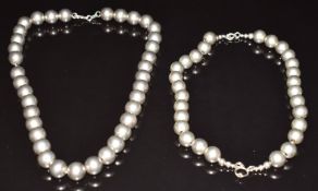 A silver beaded necklace purchased from Tiffany & Co and a silver bracelet believed to be