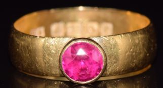 A 22ct gold ring set with a round cut ruby, Birmingham 1916, 4.6g, size O