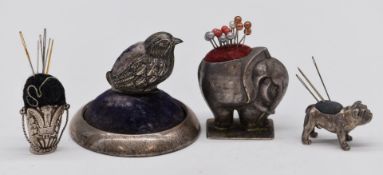 Four silver novelty pin cushions comprising hallmarked example formed as a basket with Prince of
