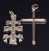 A 9ct rose gold cross (2.5g) and a yellow metal caravaca cross