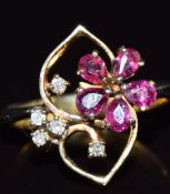 A 14k gold ring set with rubies and diamonds in a floral setting, 4g, size I/J
