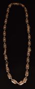 A 9ct gold necklace made up of pierced floral links, 11.2g, 47cm long