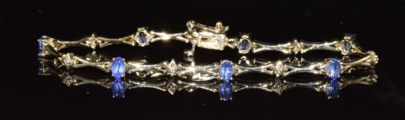 A 14k gold bracelet set with tanzanites and diamonds, 8.8g, 17cm long