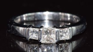 An 18ct white gold ring set with three princess cut diamonds totalling approximately 0.57ct, 4.3g,