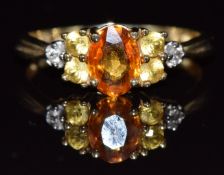A 9ct gold ring set with an orange sapphire, topaz and diamonds, 1.8g, size N