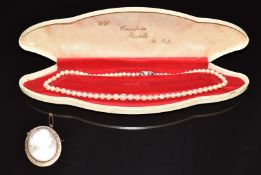 A 9ct gold brooch set with a cameo and a strand of pearls with silver clasp