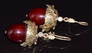 A pair of earrings in the form of acorns, set with cherry amber and old cut diamonds of