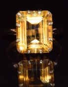 An 18ct gold ring set with an emerald cut citrine, 4.6g, size O