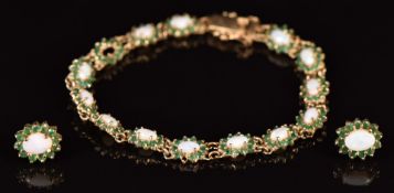 A 9ct gold bracelet set with opals and emeralds, with matching earrings, 9.3g, 18cm long