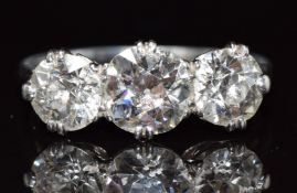 Art Deco platinum ring set with three diamonds, the largest approximately 1.2ct and remaining two