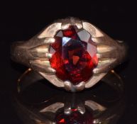 A 9ct gold ring set with an oval cut garnet, 5.2g, size R