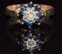 A 9ct gold ring set with a diamond and sapphires, 2.3g, size L