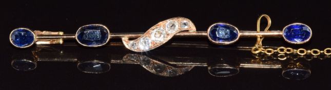 A 9ct gold brooch set with old cut diamonds and four oval cut sapphires, the largest approximately