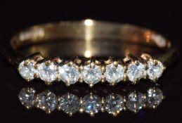 A 9ct gold ring set with seven diamonds, 1g, size L