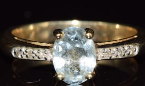 A 9ct gold ring set with an aquamarine and diamonds, 4.2g, size O