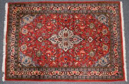 Persian rug with central lozenge against a wine ground, 162 x 110cm