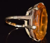 A 9ct gold ring set with a large oval cut citrine, 13.1g, size Q