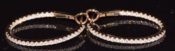 A pair of 18ct rose gold earrings set with diamonds and further diamonds to the inner band 4.7g