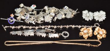 A silver charm bracelet, silver RAF brooch, silver elephant bracelet, silver train bracelet, 9ct