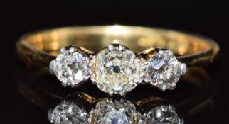 An 18ct gold ring set with three old cut diamonds, the largest approximately 0.4ct, 3g, size S