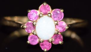 A 9ct gold ring set with an opal surrounded by rubies, 1.7g, size N