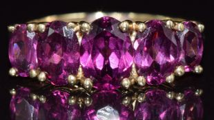 A 9ct gold ring set with five garnets, 2.3g, size J