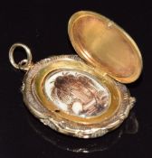 Victorian/ Georgian gold locket set with plaited hair to the border, opening to reveal a scene
