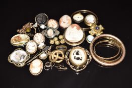 A collection of Victorian cameo brooches, other Victorian brooches, rolled gold bangles, cameo stick