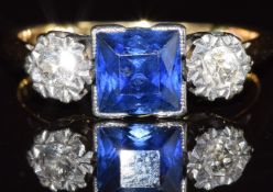 A c1920 18ct gold ring set with a square cut sapphire and two old cut diamonds, 3.5g, size K