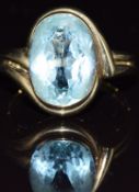 A 9ct gold ring set with an oval cut topaz of approximately 6.6ct, 5.7g, size P