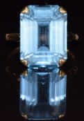 A yellow metal ring set with an emerald cut topaz, 6.1g, size O