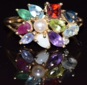 A 9ct gold ring set with garnet, ruby, emerald, sapphire, amethyst, peridot, opal, pearl, topaz
