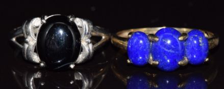 Two 9ct gold rings, one white gold set with onyx, the other set with lapis lazuli, 6.6g, size U & R