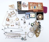A collection of costume and silver jewellery including white metal charm bracelet, brooches,