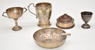 Hallmarked silver items comprising mug, egg cup and trophy cup, together with an ashtray marked