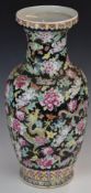 Chinese famille noir pedestal vase decorated with dragons amongst flowers, with seal mark to base,