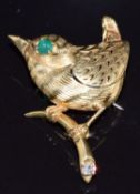 Cartier 1963 novelty bird brooch modelled as a wren perched on a branch, with pierced wing, an