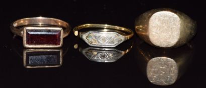 A 9ct gold signet ring (size P, 4.3g), a 9ct gold ring set with a garnet (size P, 3.2g) and an