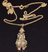 A 9ct gold reticulated clown pendant set with paste (5.3g) on 18ct gold chain 3.8g, 52cm long