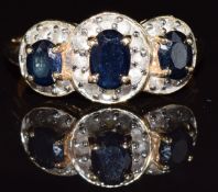 A 14k gold ring set with three sapphires and diamonds, 2.9g, size N/O
