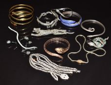 A collection of bangles including serpent rolled gold, silver snake/ serpent bangles, two snake