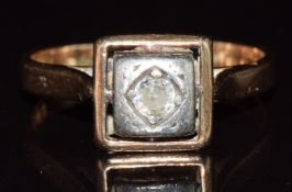 A 14ct gold ring set with a diamond in a square white gold setting, 3.7g, size N